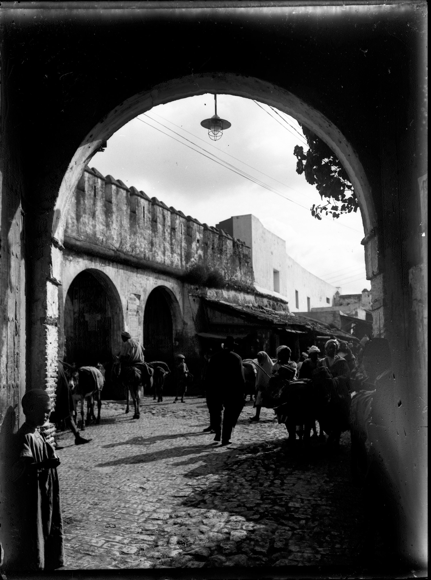 Les Deux Portes - People and donkeys in Medina doorway 