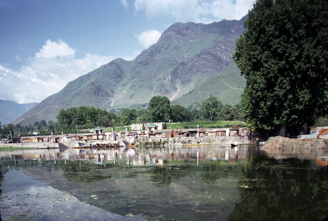 General view from Dal Lake looking northeast, showing the two small pavilions (with green roofs) at the northwest and southwest corners of the garden. This view shows the access to the garden from the lake