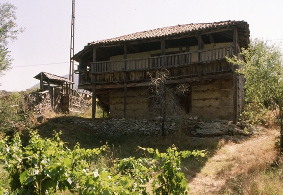 <p>This large summerhouse has a large covered çardak with seating projecting along the railing edge. The reinforced masonry has received a plastered coating over the masonry to seal the dryset stonework that is typically present; this treatment accentuates the ends of the interlocking wooden cross members of the reinforcing. The upper level walls, made of lighter construction, are also faced with a plaster surface. A compound reinforced stone wall and gate indicate that the area was more formally enclosed in the past.</p>