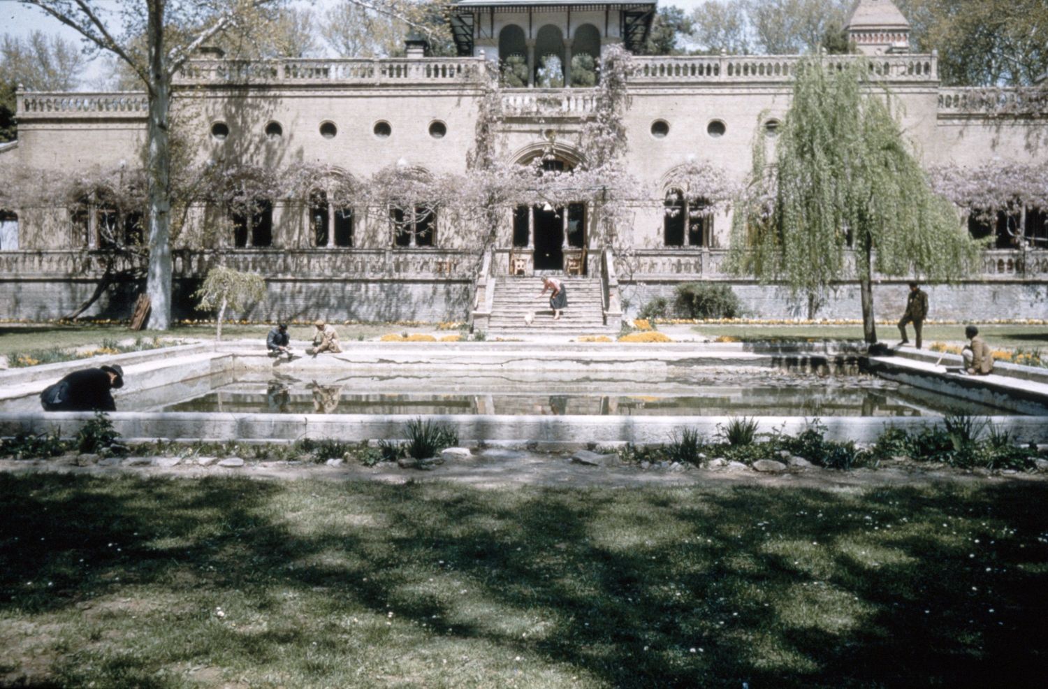 Exterior view from south, showing the main elevation with veranda and open pavilion above.