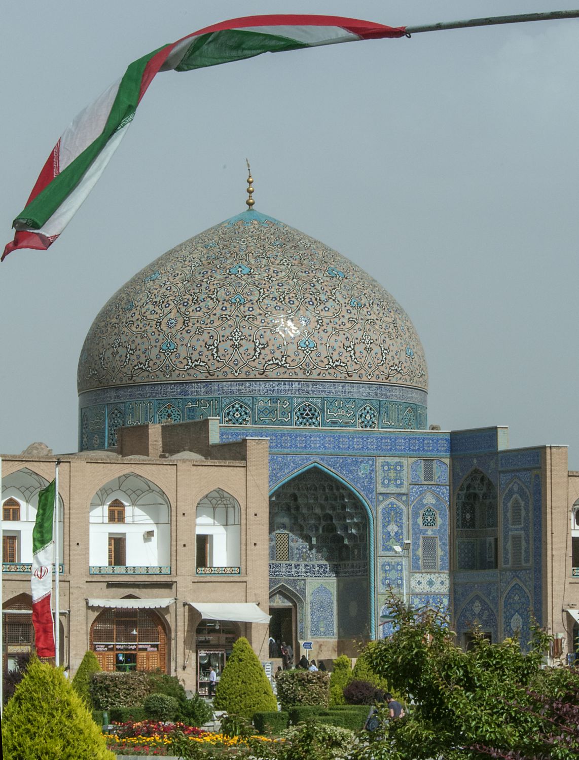 View of portal and dome from northwest, Iranian flag flies in foreground. 
