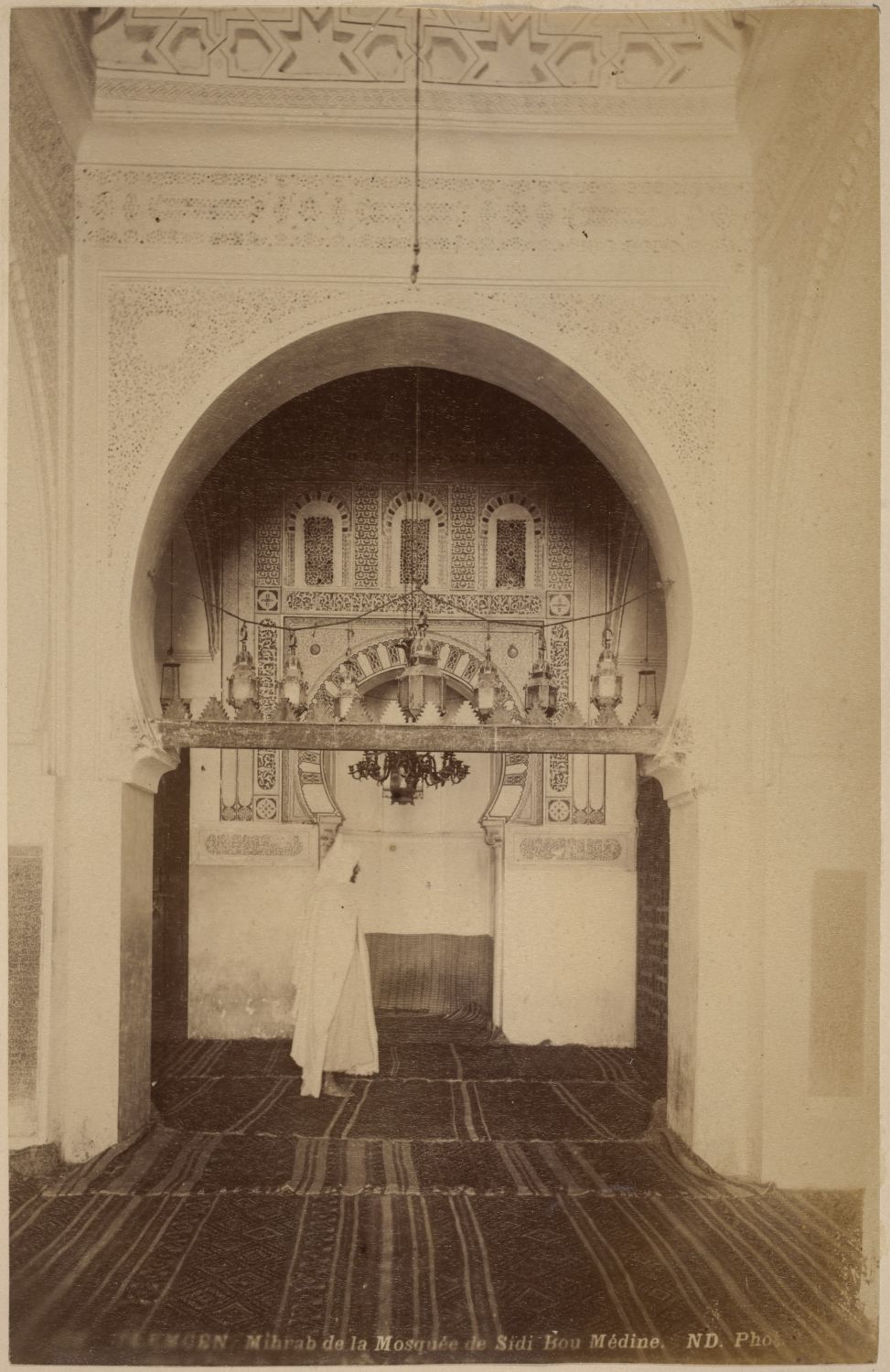 View of the mihrab, man in traditional clothings standing in the foreground