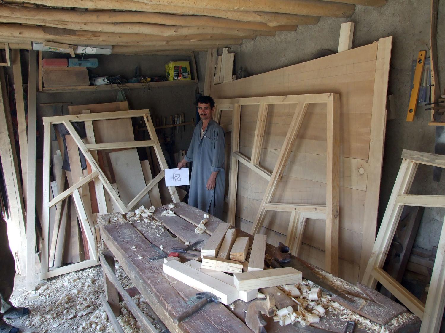 Carpenter in Faizabad making double glazed non-orthogonal windows