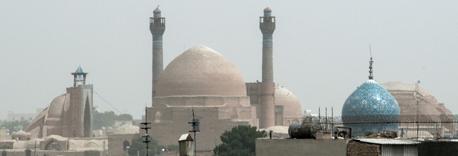 Masjid-i Jami' (Isfahan) - Distant view from south, showing rear of southwest iwan and southwest dome. The dome of Harun-i Vilayat is visible in foreground toward right.