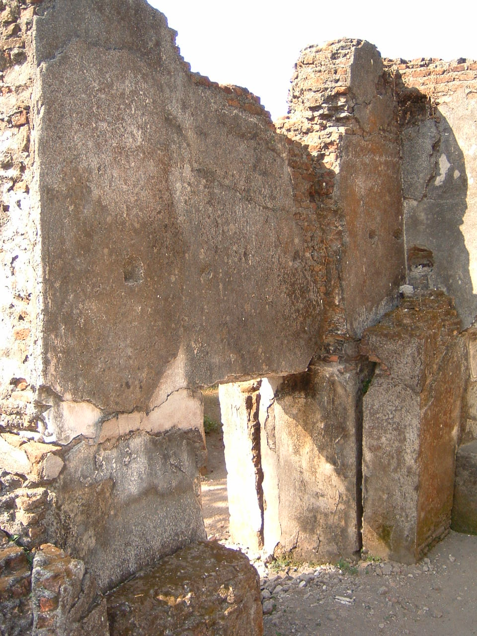 Detail view looking northwest at wall with partially blocked doorway