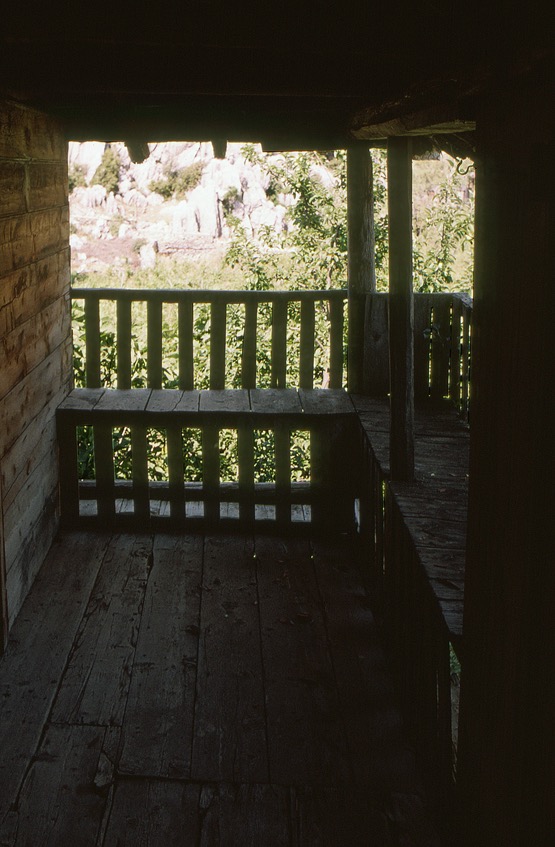 <p>This smaller çardak area is located at the top of a stair and isolated from the larger portion through an adjacent doorway. The simple plank contruction provides places for occupants to sit near the edge to enjoy the breezes of the summer winds. The slats that form the seat and back supports give a measured view of the gardens below.</p>