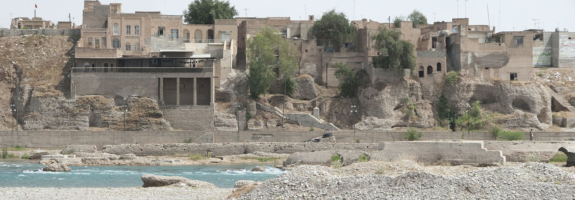 View of houses along riverbank upstream from Pul-i Qadim (Old Sasanian Bridge).