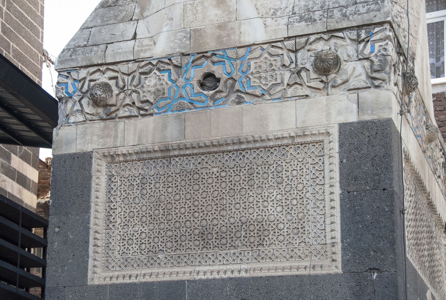 View of plaque with geometric ornament on base of minaret.
