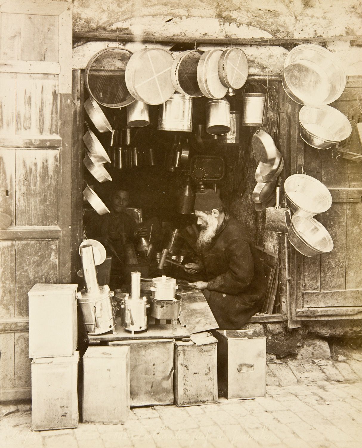 View of a tinsmith working in his shop
