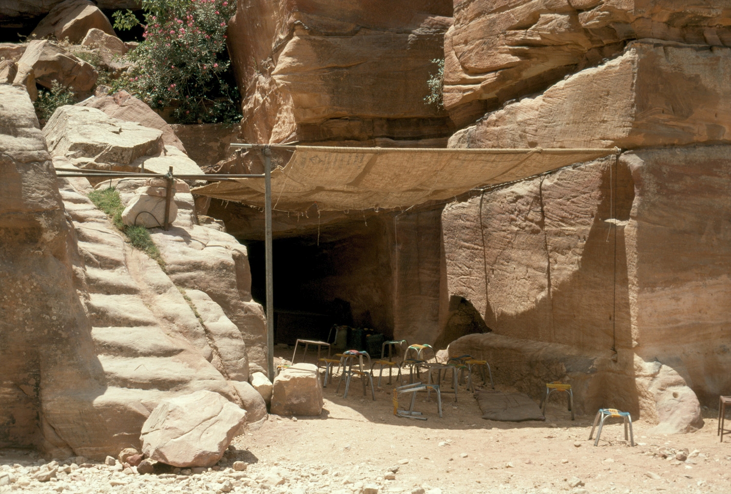 Outer Siq, stone steps and tent shelter at cave
