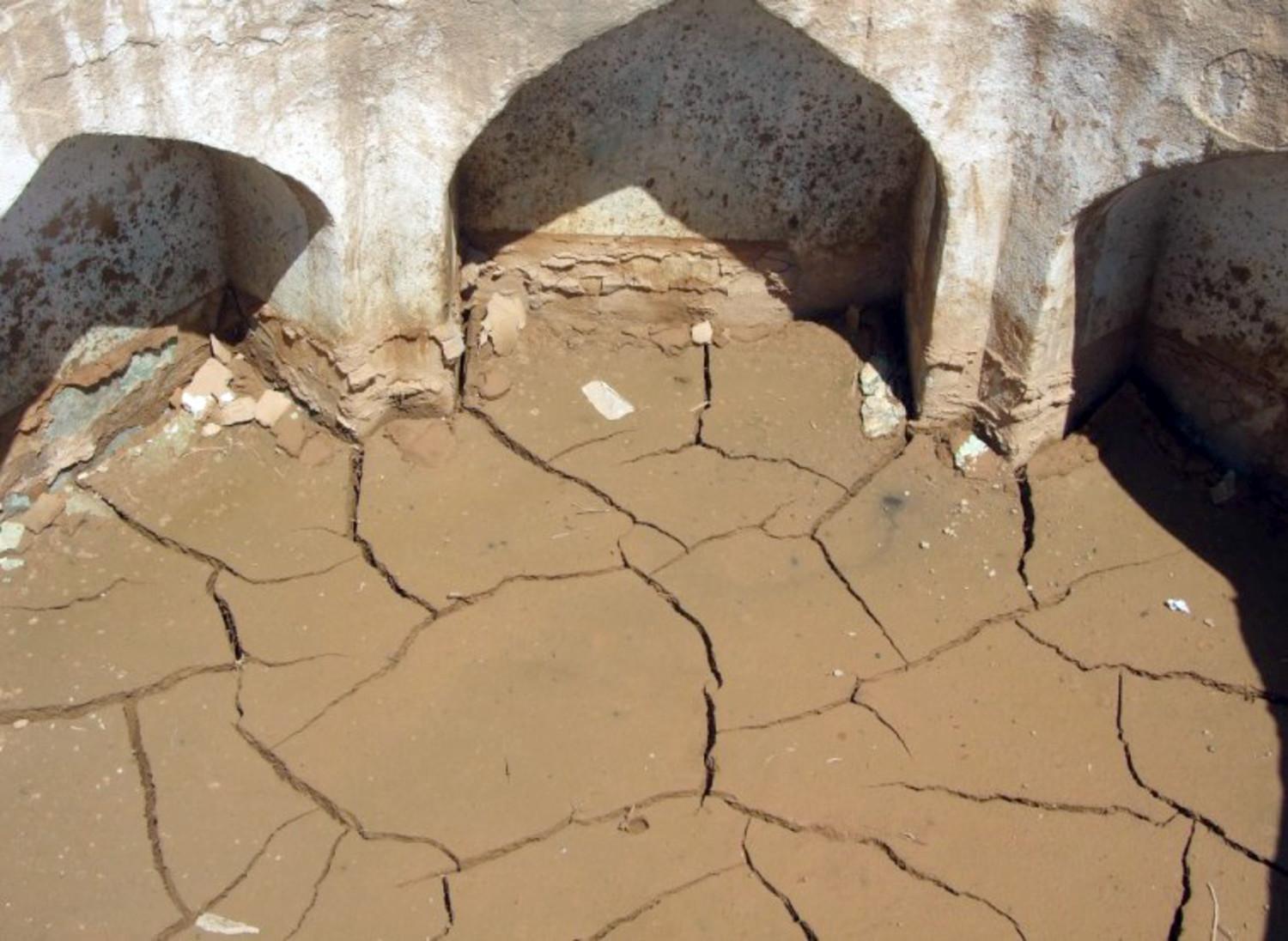 Receding water leaves behind flood mud, that could crack open the hammam in freezing Kholm winters