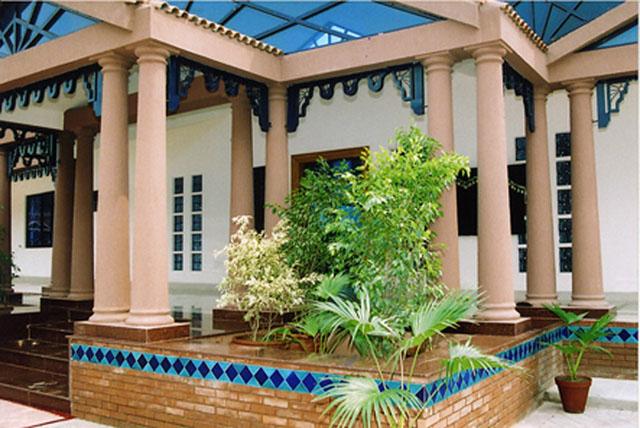 Planter and intricate architectural features flanking the entrance