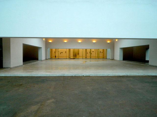 <p>Approach to main entrance to the courtyard with prayer hall lit in background</p>