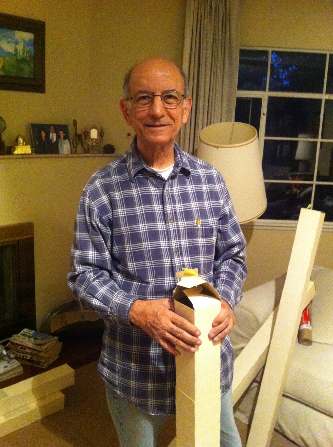 Besim Hakim holding a roll of his drawings and maps from the 1970s, in Albuquerque, New Mexico, October 2017