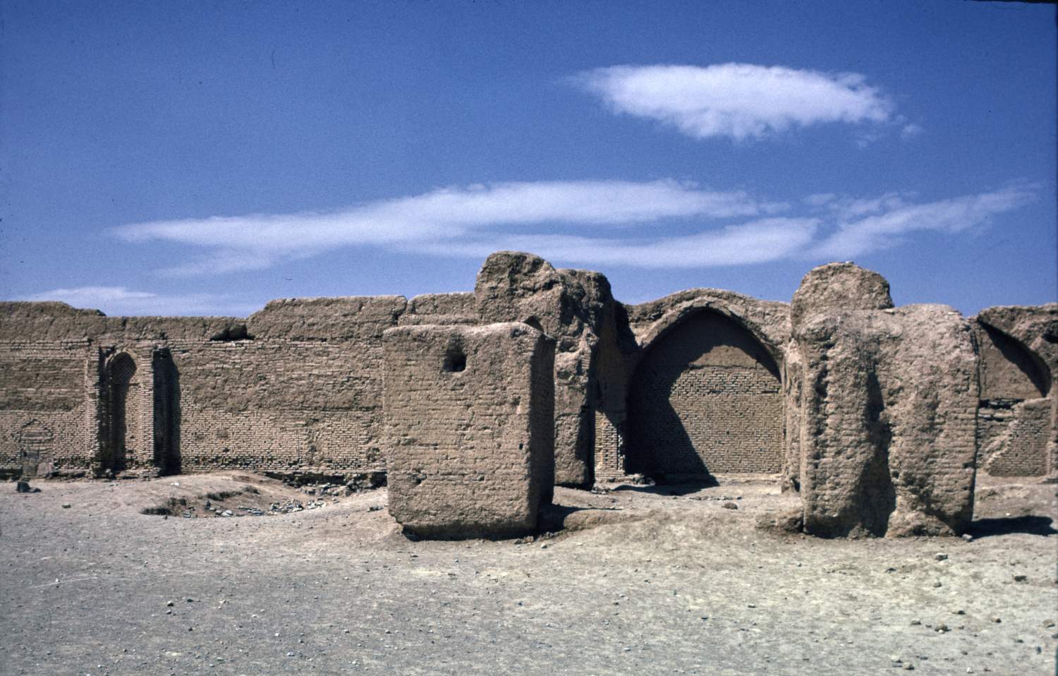 View toward southwestern enclosure wall (qibla wall) showing brick masonry from second building phase, and remnants of piers in foreground.