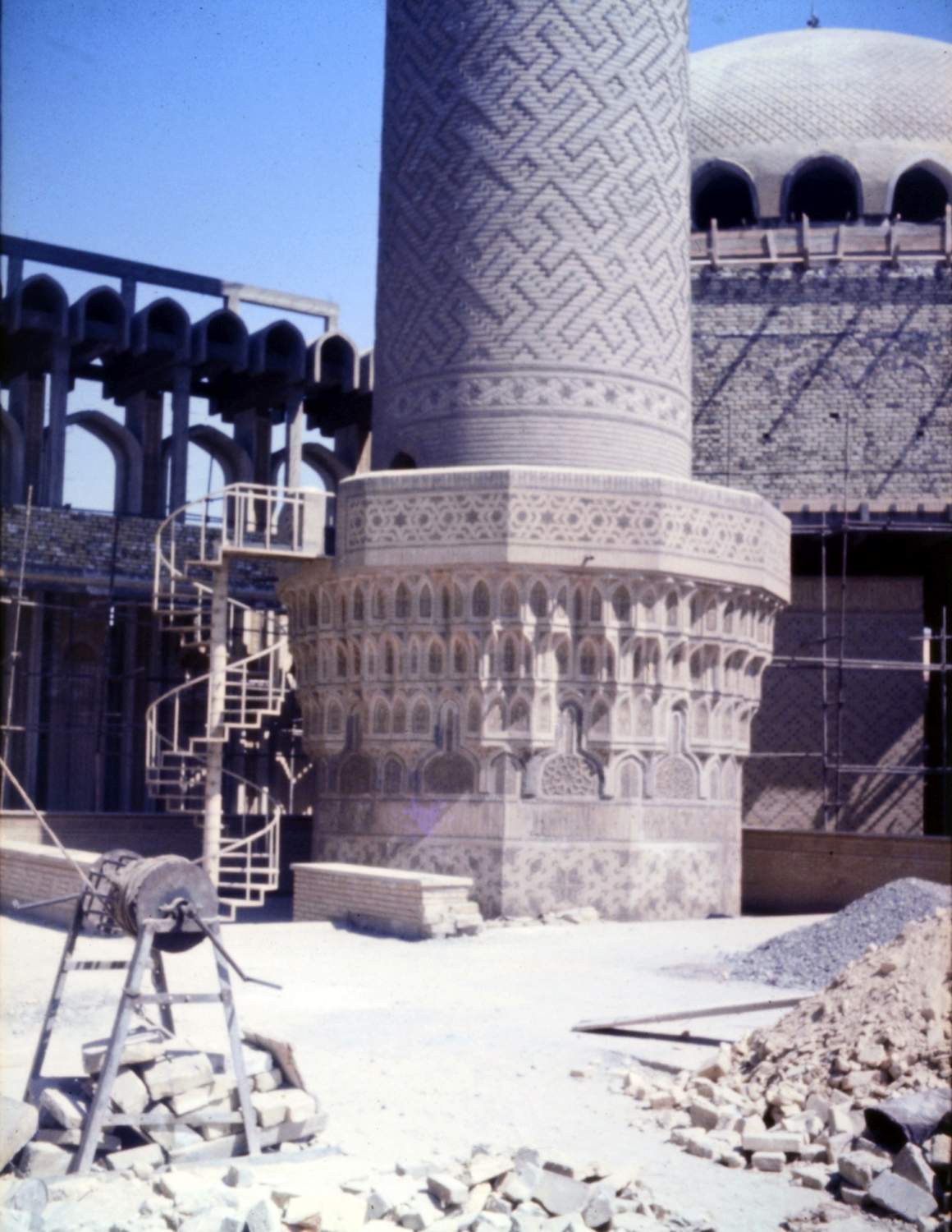 Exterior view across sahn or courtyard during construction.