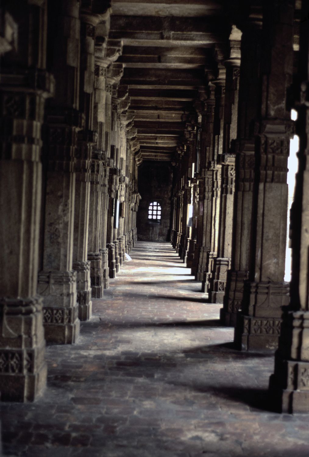 View along a pillared aisle inside the prayer hall.