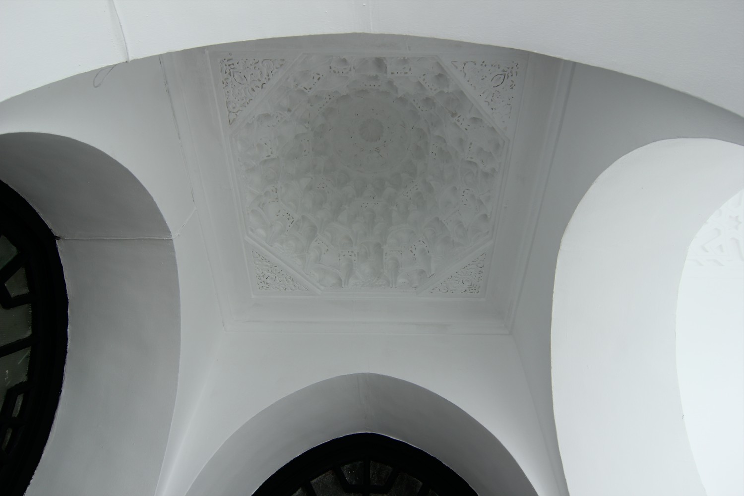 Interior view of dome in the crossing of two galleries showing muqarnas