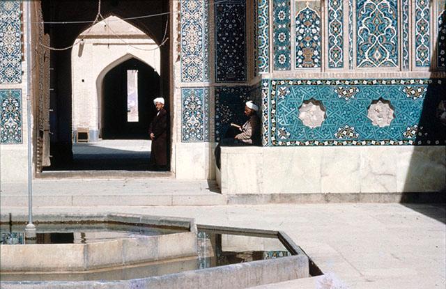 Exterior view showing part of the basin in the forecourt and the lower portion of portal iwan with tile mosaic decoration