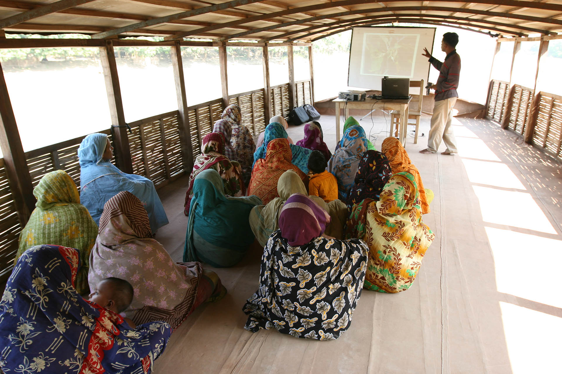 <p>Parents and villagers receiving trainings on flood-resistant crops and climate adaptation techniques on the school-boat.</p>