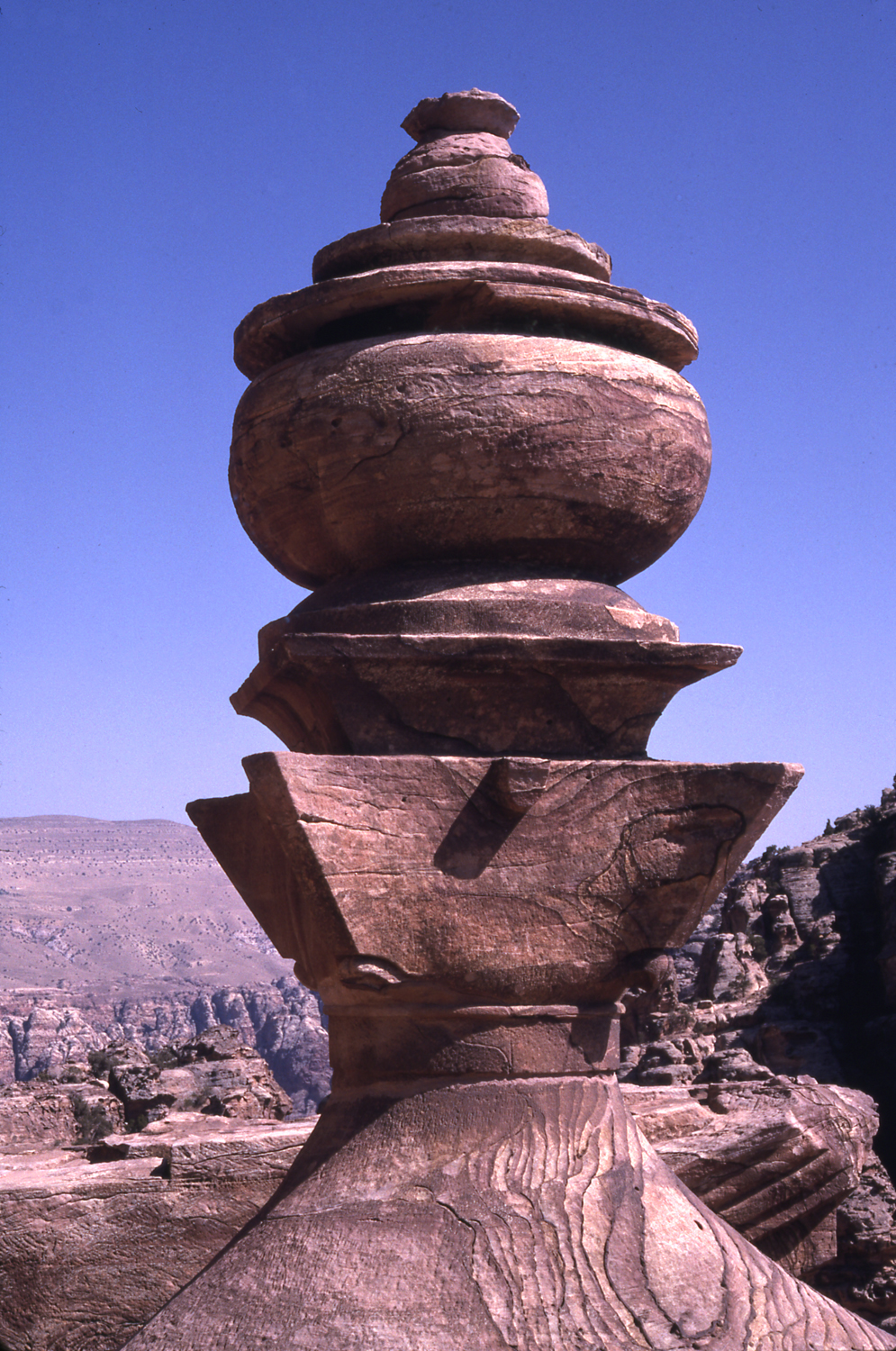 Detail of free-standing urn atop central portion of front facade