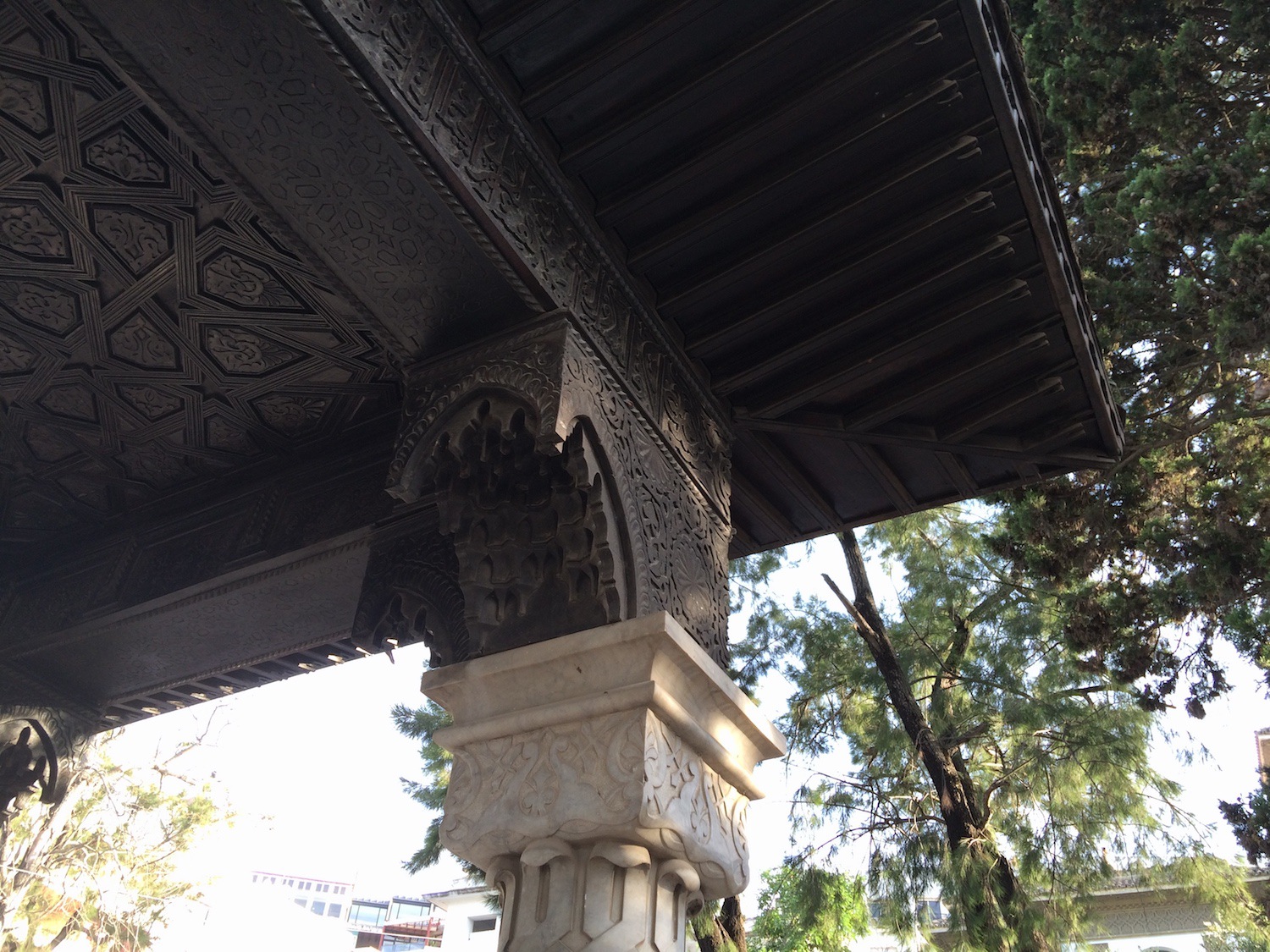 Detail view of a column capital and wood ceiling