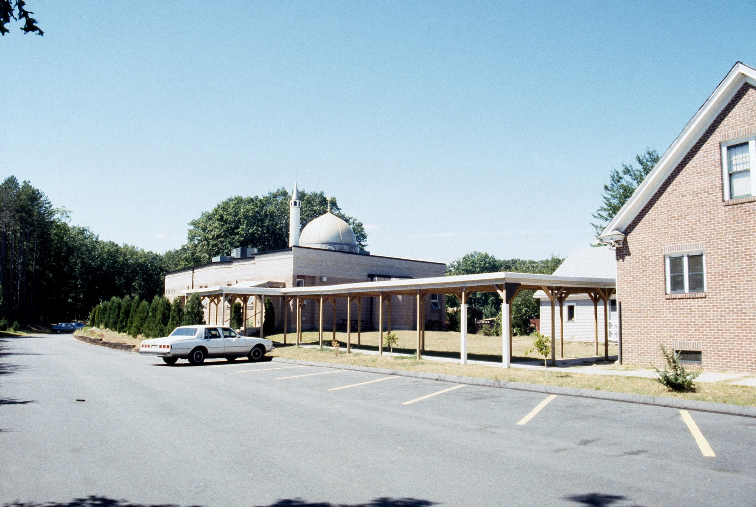 Islamic Society of Western Massachusetts - View from parking lot, looking west; the covered walkway and houses are no longer extant