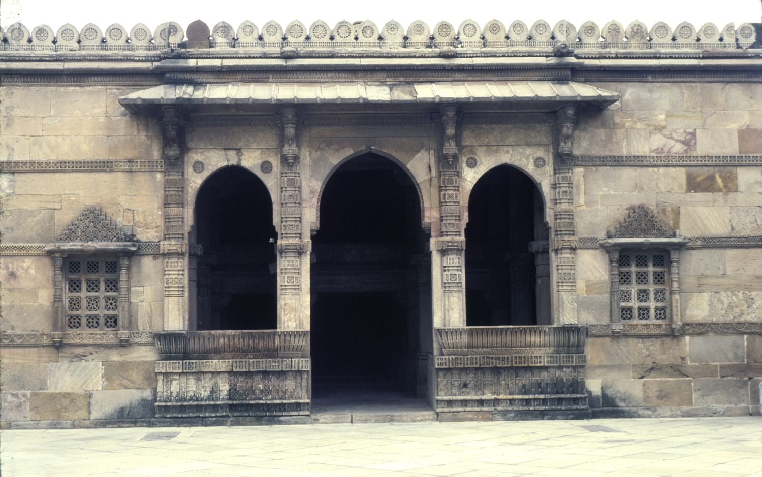 View of three-arched entrance to prayer hall flanking main portal on east facade.