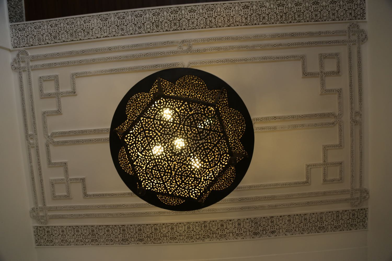 View of a large, brass light fixture in the reception area 